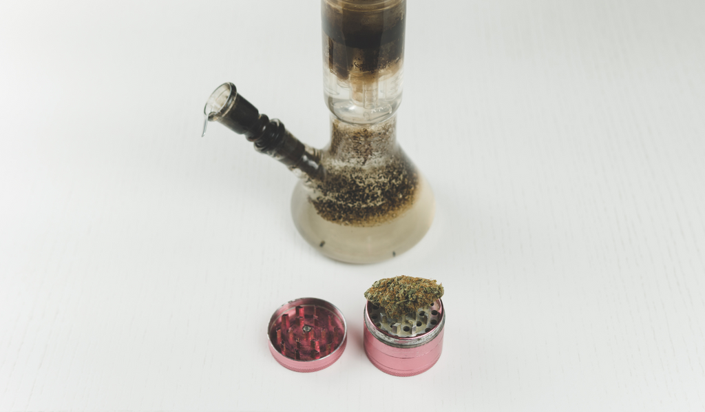 A dirty bong with a grinder