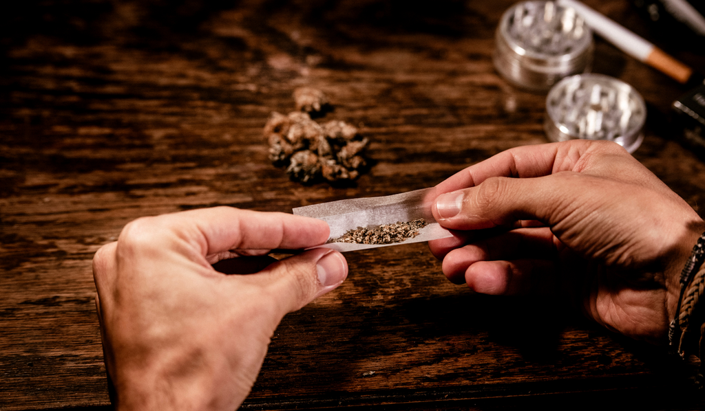 A person rolling a joint with two hands