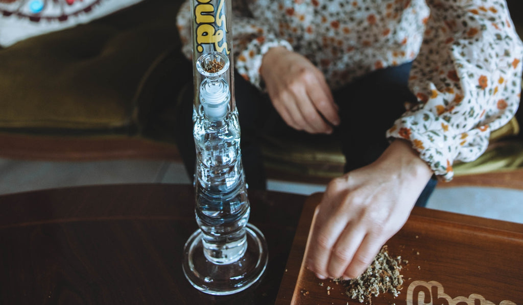 A woman preparing a gripper bong