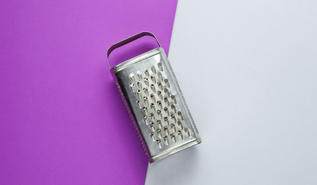 Cheese grater on a colourful background