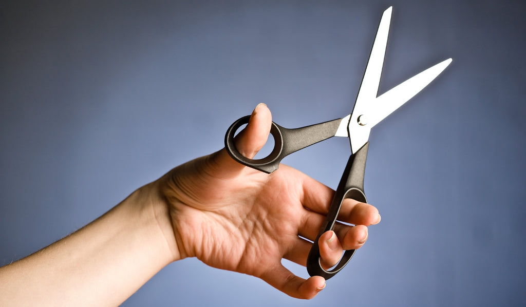 Hand holding scissors