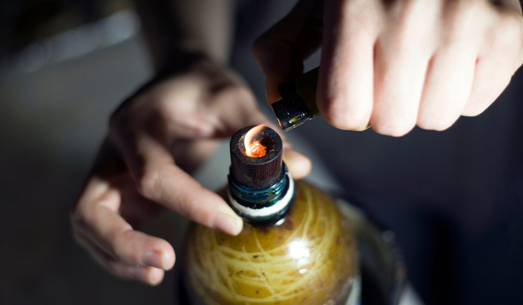 Person lighting water bottle bong