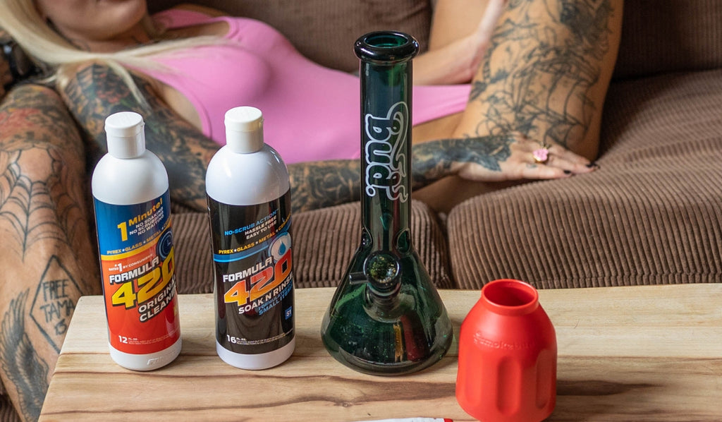 Two bottles of Formula 420 bong cleaner and a glass bong