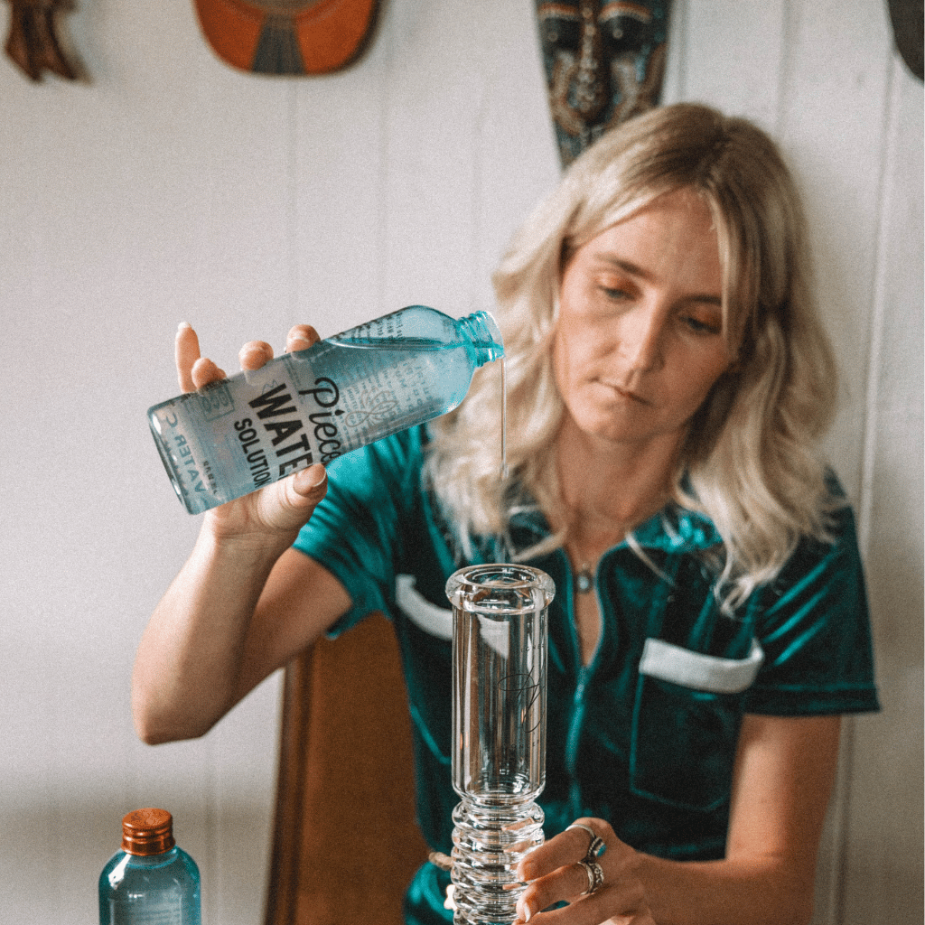Woman pouring Piece Water Solution into a bong